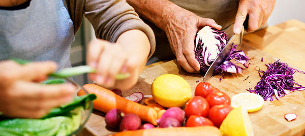 elderly couple preparing food at home Image