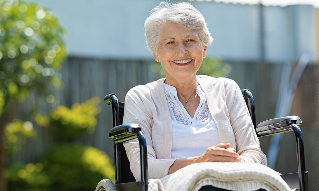 woman in wheelchair smiling outdoors