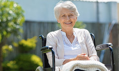 woman in wheelchair smiling outdoors