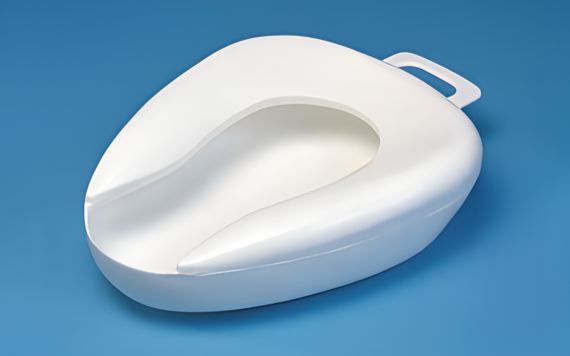 A white bedpan with a handle on a blue background.