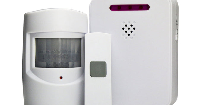 A motion sensor set with three white devices: a curved sensor, a rectangular remote with a grey button, and a square base unit with purple lights.