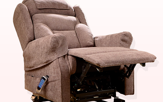 A brown upholstered recliner chair with padded armrests, an extended footrest, and a remote control attached to the side for adjusting settings.
