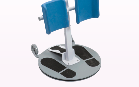 A close-up of a leg stretching device with a circular base, foot outlines, blue padded supports, and two small side wheels.