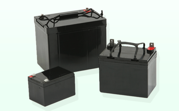 Three black batteries and a light background, largest in back, medium to the right, smallest to the left, all with handles and top terminals.