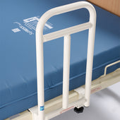 Bariatric grab handle fixed to a hospital bed with a blue mattress, shown in use for patient support, side view.