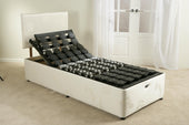 Single electric adjustable bed base with profiling sections, raised headrest and black support grid, front angle view.