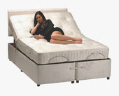 Woman lying on a Restwell Pocket Sprung Mattress on an electric adjustable storage bed, side view.