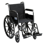 Black steel self-propelled wheelchair with armrests, footrests and large rear wheels, side view.