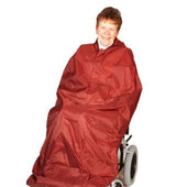 Blue shower-proof nylon Drive Wheelchair Coverall worn by a smiling wheelchair user, white background, front view.
