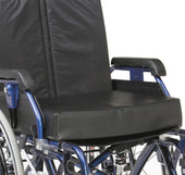 Drive 4 inch vinyl memory foam cushion, 18 inch wide, placed on blue wheelchair with visible armrests and wheels, close-up view.