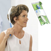 Woman scratching her back with 370 mm Etac Hair Brush Long, product packaging shown inset, in use view.