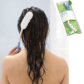 Person with wet hair using Etac Hair Washer long handle on scalp, Etac box in corner, in use view.