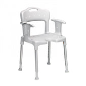 Grey Etac Swift shower chair with armrests, adjustable metal legs and backrest, front angle view.