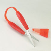 Green Mini Easi-Grip scissors with pointed end, stainless steel blades and safety cover on a light background, top view.