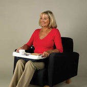 Woman in red top using a Homecraft Lap Tray with non-slip mat, sitting in black chair holding cup and plate, in use view.