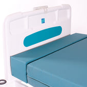 Sidhil Softrest Mattress Extension with blue foam on hospital bed, white headboard with blue panel, close-up view.
