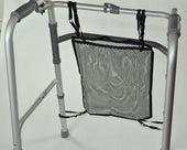 Able2 walking frame net bag attached to silver frame, white background, front view.