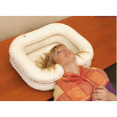 Able2 Deluxe Inflatable Shampoo Basin used for washing hair in bed, woman with colourful towel around shoulders, in use view.