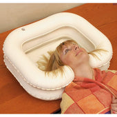 Able2 Deluxe Inflatable Shampoo Basin used for washing hair in bed, woman with colourful towel around shoulders, in use view.