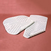 Pair of white Rubbergrip Bath Mats with textured, slip-resistant surfaces on a pink background, top view.