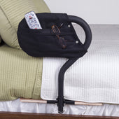 Stander Bed Cane with cushioned handle and storage pouch containing a remote and glasses, side view.
