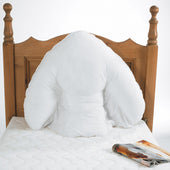 Harley Batwing Pillow on bed against wooden headboard, magazine beside pillow, in use view.