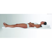 Woman lying on back on Harley Memory Foam Mattress Topper with cover and pillow, arms on abdomen, in use view.