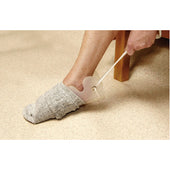 Able2 Sock/Stocking Aid with handles for pulling on socks while seated, shown in use.