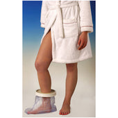 Person in a white bathrobe with Able2 waterproof cast protector on right foot, standing on blue and white floor, in use view.