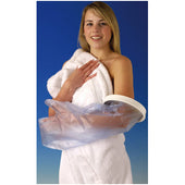 Woman in a white towel wearing a waterproof cast protector on her short arm, blue background, front view.