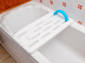 White bath board with blue handle for sitting in the tub, shown resting across a bathtub, side view.