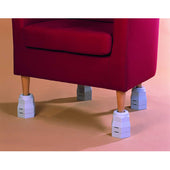 Red armchair with wooden legs on furniture raisers on a light brown floor, front view.