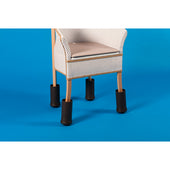 Chair with Leg-X Furniture Raisers fitted to each leg on a bright blue background, side view.