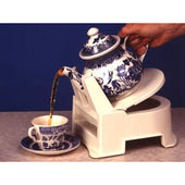 Gordon Ellis All-Purpose Tipper pouring hot water from blue and white teapot into matching teacup, in use.