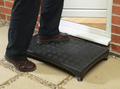 Langham Plastic Half Step used to assist a person stepping up to a brick house doorway, in use view.