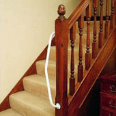 Steel newel post rail fixed beside carpeted stairs at the bottom, attached to the newel post, side view.