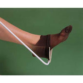 Homecraft Brevetti Sock and Stocking Aid helping a foot put on a dark stocking, green background, in use view.