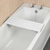 Savanah slatted bath board placed over a bathtub, shown against white tiled walls, side view.