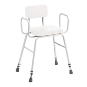 Black perching stool with armrests, cushioned backrest, and rubber-tipped legs for support, side view.