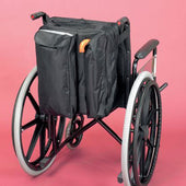 Wheelchair crutch bag fitted to black wheelchair, pink background, side view.