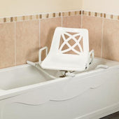 White rotating bath seat with armrests placed over a bathtub in a tiled bathroom, side angle view.