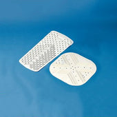 Pair of white bath and shower mats with tread pattern on a blue background, top view.