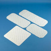 Four white rectangular and square bath and shower mats on a blue background, top view.