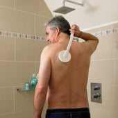 Man applying cream to his back with Homecraft Dual Function Lotion and Cream Applicator in the shower, in use view.