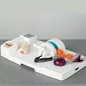 Homecraft Kitchen Workstation with attachments, halved red onion and peeled parsnip on grey countertop, front view.