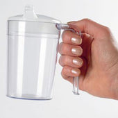 Hand holding a clear plastic shatterproof mug with an anti-spill lid and handle, in use view.