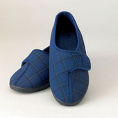 Mens navy blue plaid washable slippers with black soles, shown on a light background, side view.