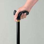 Hand holding Homecraft Contoured Grip Ergonomic Stick with Woodland Flowers design, plain light background, in use view.