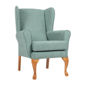 Light green Restwell Queen Anne Fireside Chair with lumbar support and wooden legs, front view against white background.