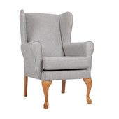 Grey Queen Anne fireside chair with wooden legs and sprung seat cushion, front view.
